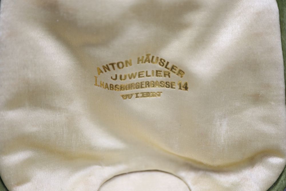 An early 20th century German jugendstil 585 yellow metal and facetted garnet set brooch,